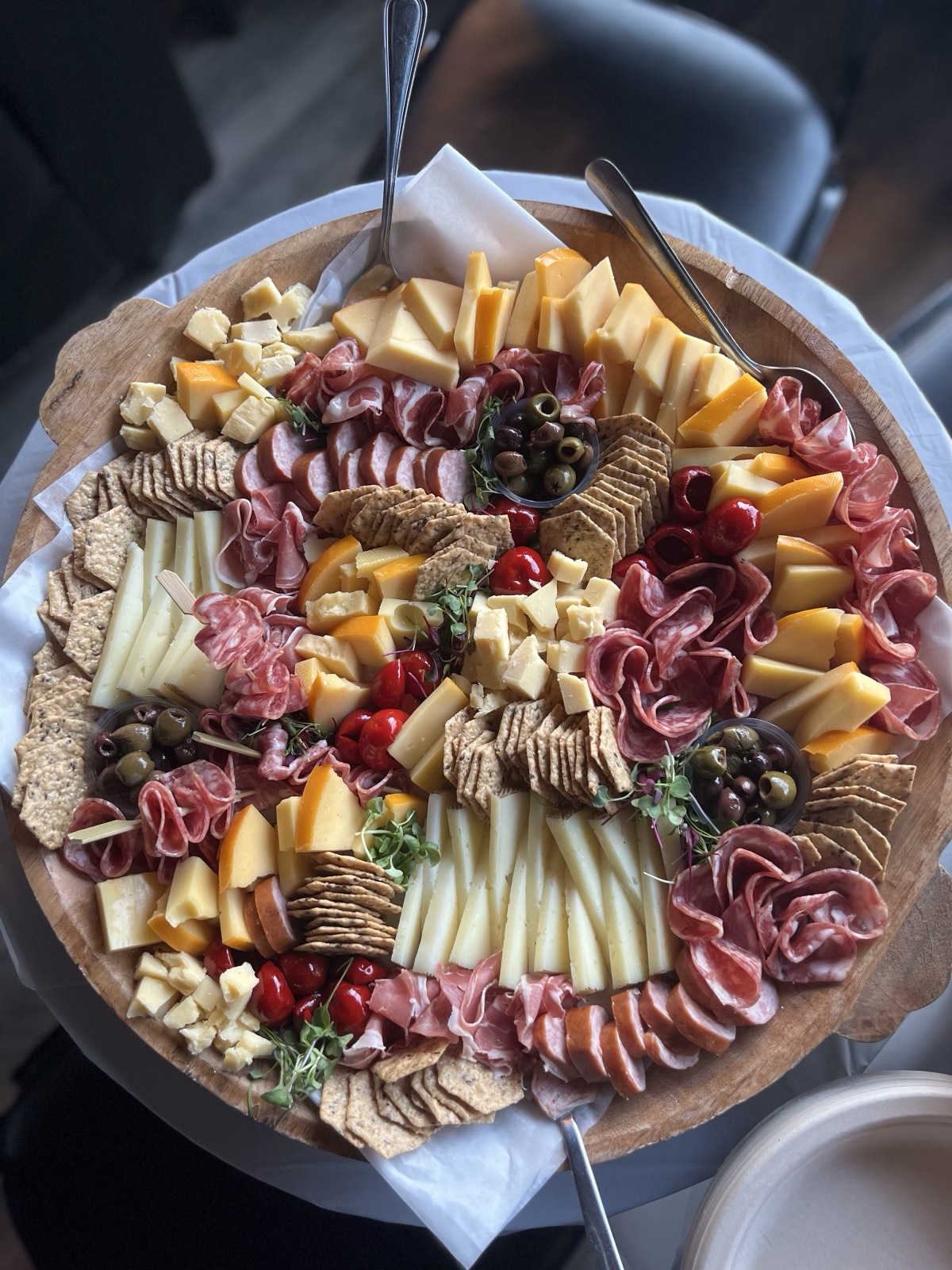A styled grazing board with cheeses, cured meats, fruit and crostini for a birthday party