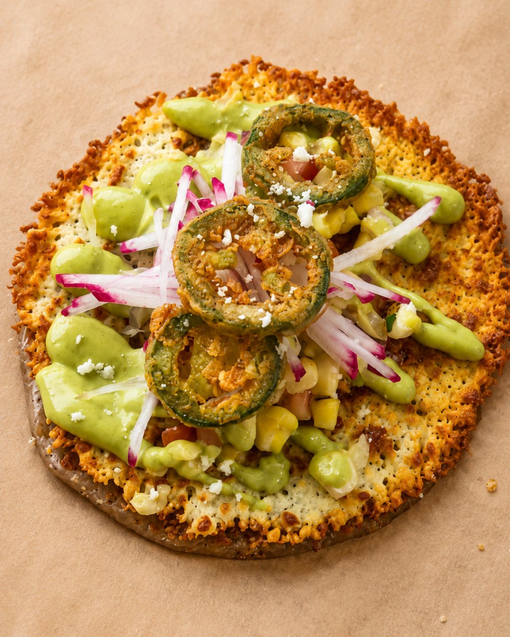 A griddled taco with cotija, summer corn, jalapeño and radish