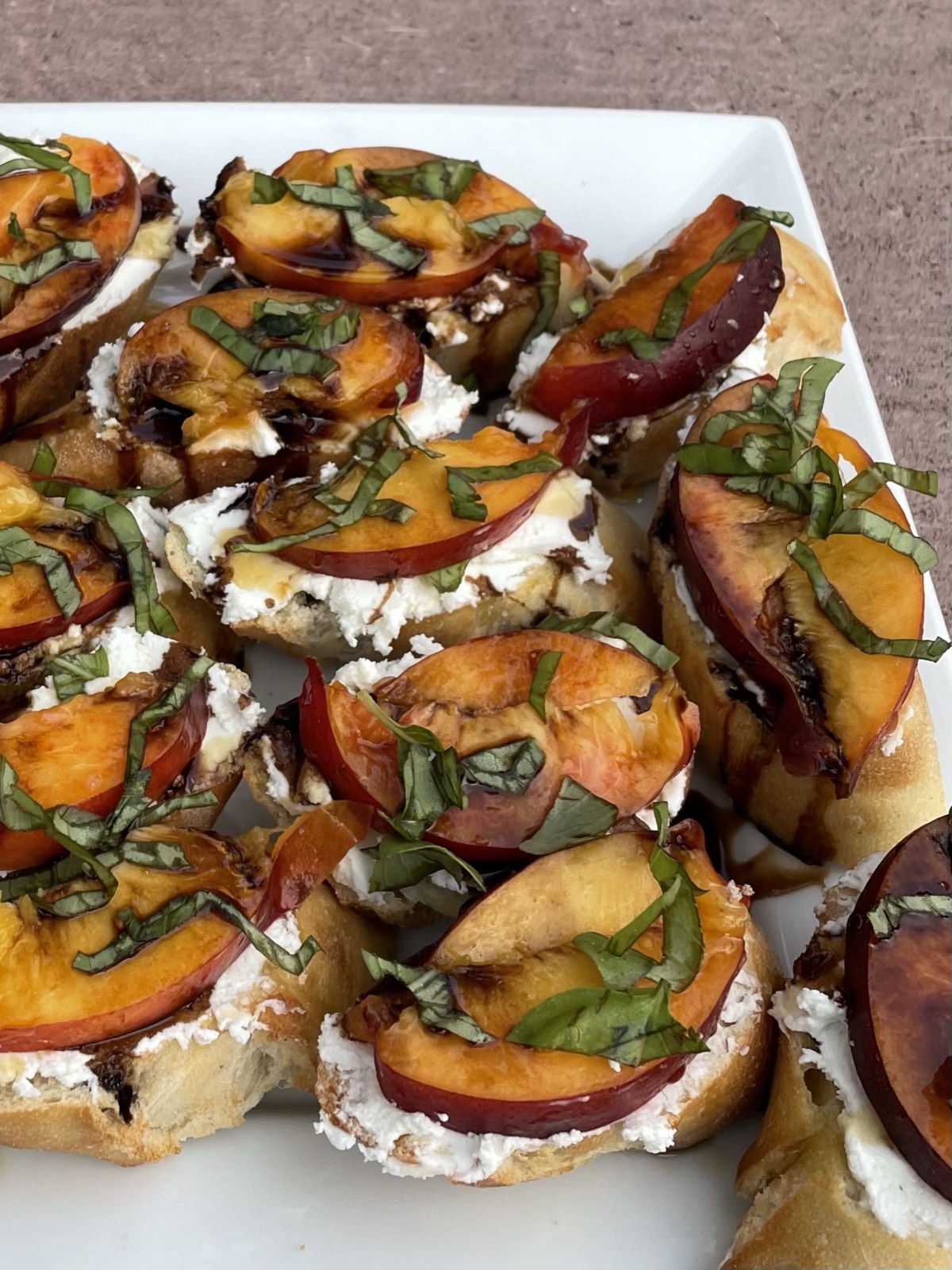 Roasted peach crostini with herbs, part of a seasonal bridal shower spread